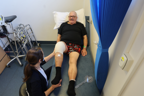 Patient undertaking rehabilitation with the physiotherapy team after knee surgery